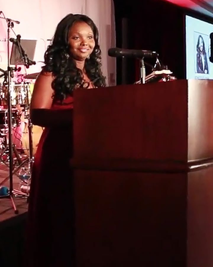 Marie Zoutomou-Quintanilla speaking at the Gatsby Gala